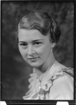 A young woman poses for a school portrait